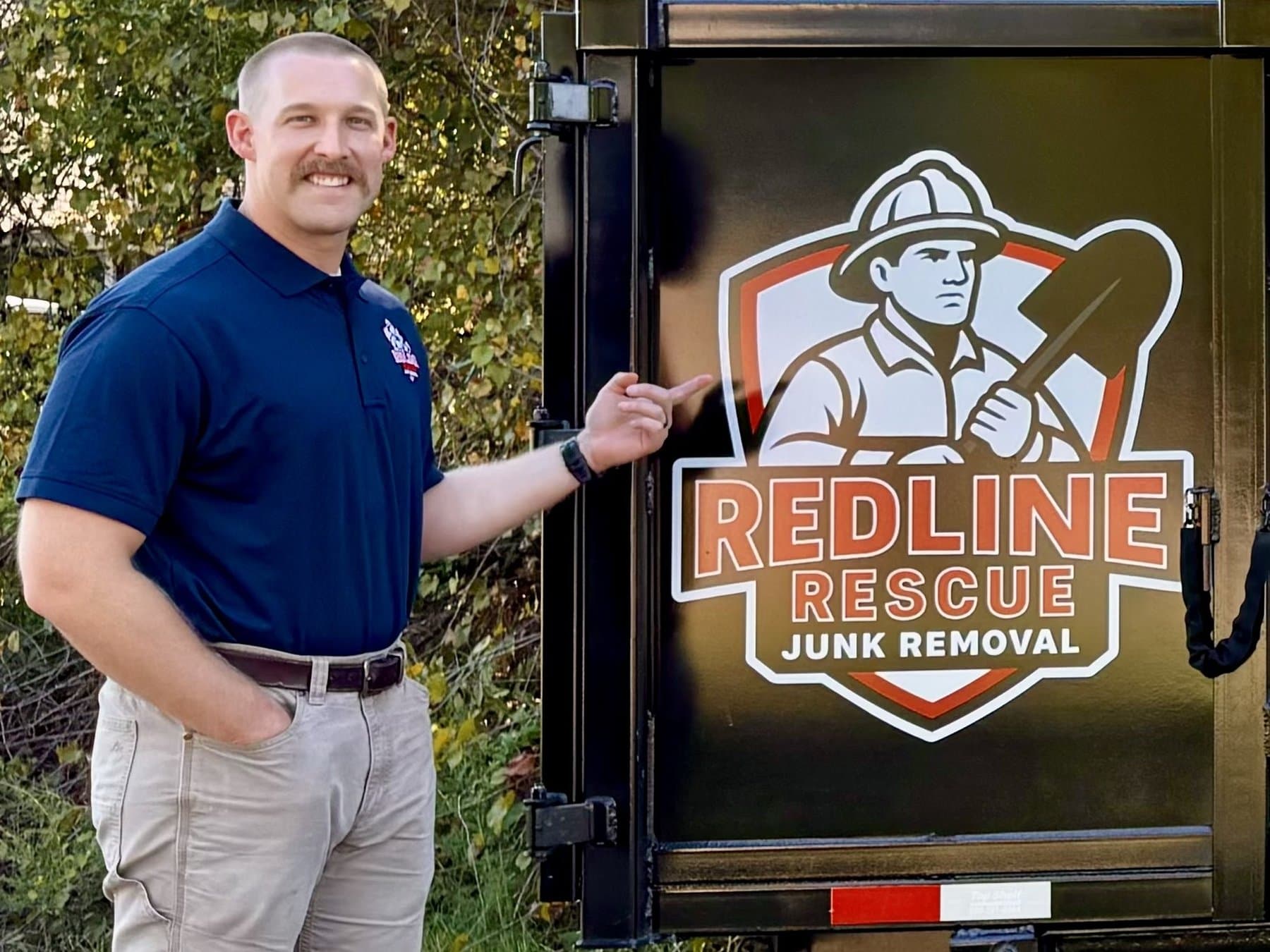 Dave, owner of Redline Rescue Junk Removal, standing beside the Redline Rescue trailer